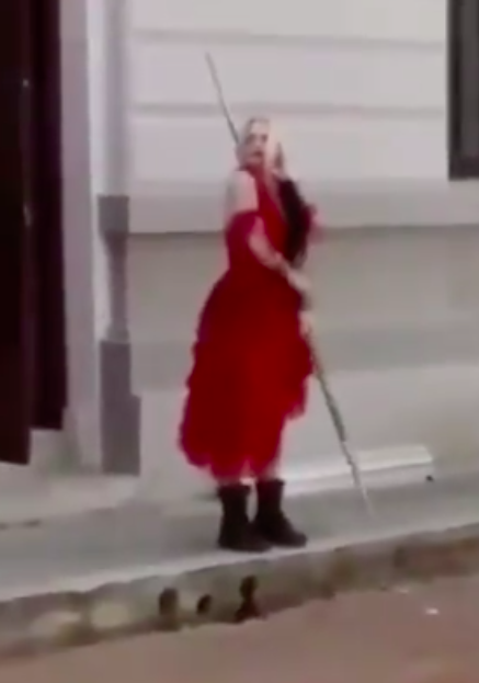 Margot on set as Harley in red dress cap 1.png